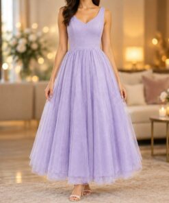 Woman twirling in a lavender tulle dress at a party, shown from the neck down